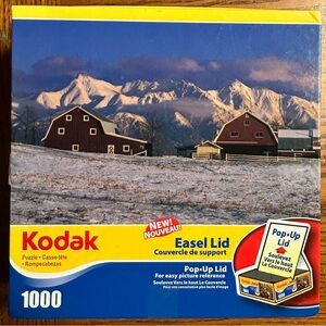 Kodak Puzzle with Red Barns and Snowy Mountains